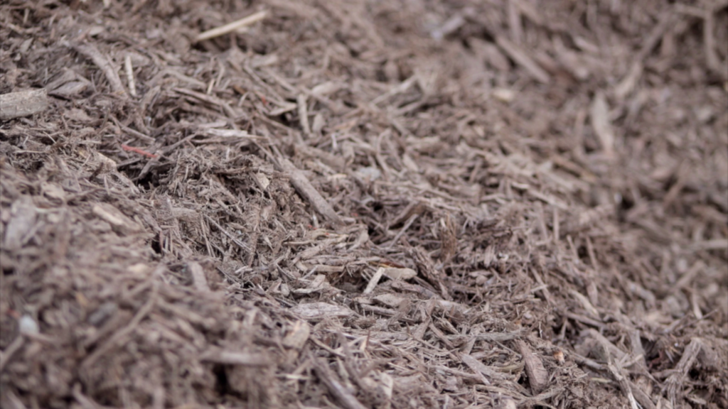 A photo of brown mulch from Straight Line Fence.