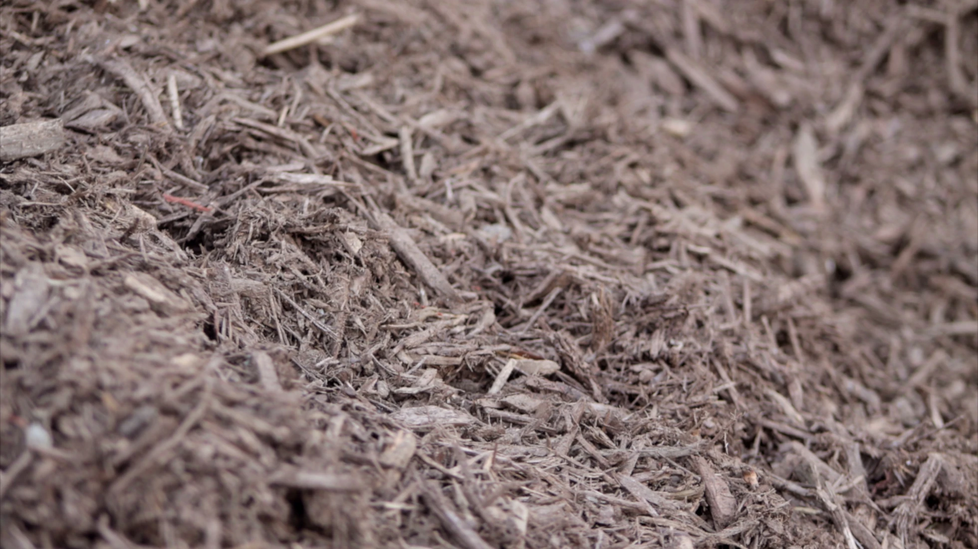 A photo of brown mulch from Straigh Line Fence.